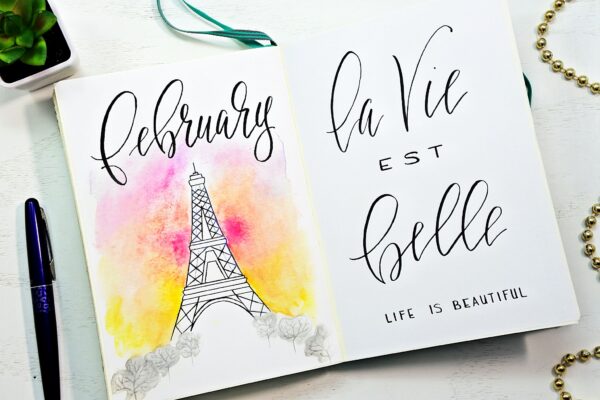 Eiffel tower themed Bullet journal cover page and hand-lettered quote for February.