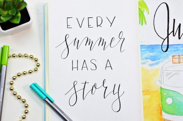 Hand lettered summer quote in a bullet journal.